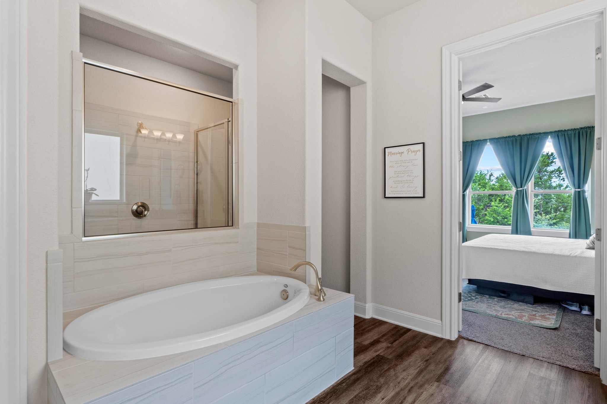1329 Siena Sunset Road Leander, TX 78641 - Photo 17 of 33 Ensuite mater bath with garden tub and walk-in shower and a view through the master of the green belt beyond.