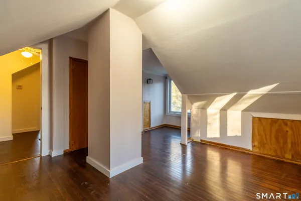 a view of a hallway with wooden floor