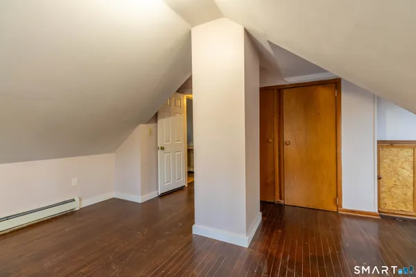 a view of an empty room window and wooden floor