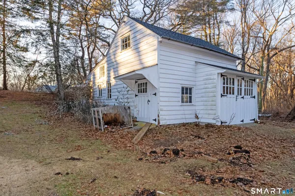 a view of a house with a yard and tree s