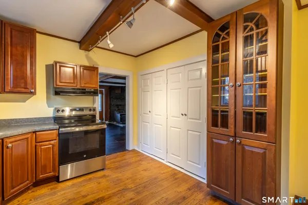 a kitchen with stainless steel appliances granite countertop a refrigerator and a stove top oven