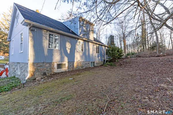 a view of dirt yard with a tree