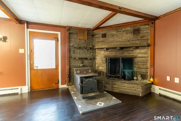 a living room with hard wood floors and a fireplace