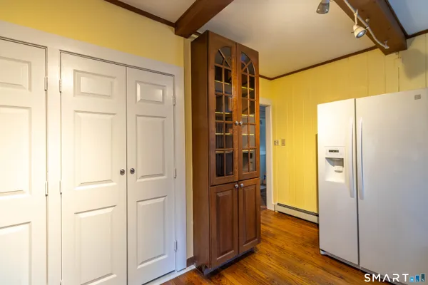 a view of a hallway with wooden floor
