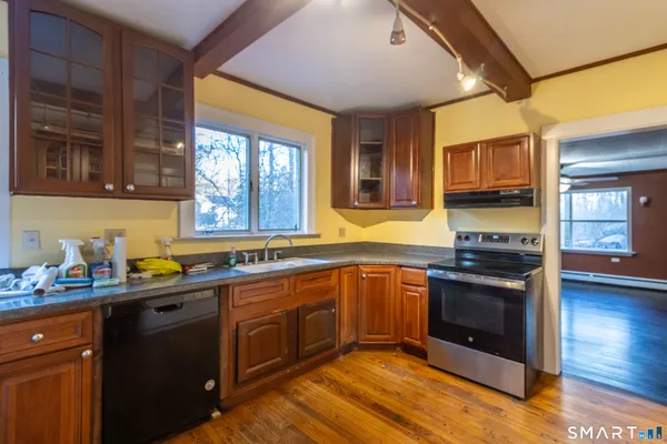 a view of empty room with wooden floor