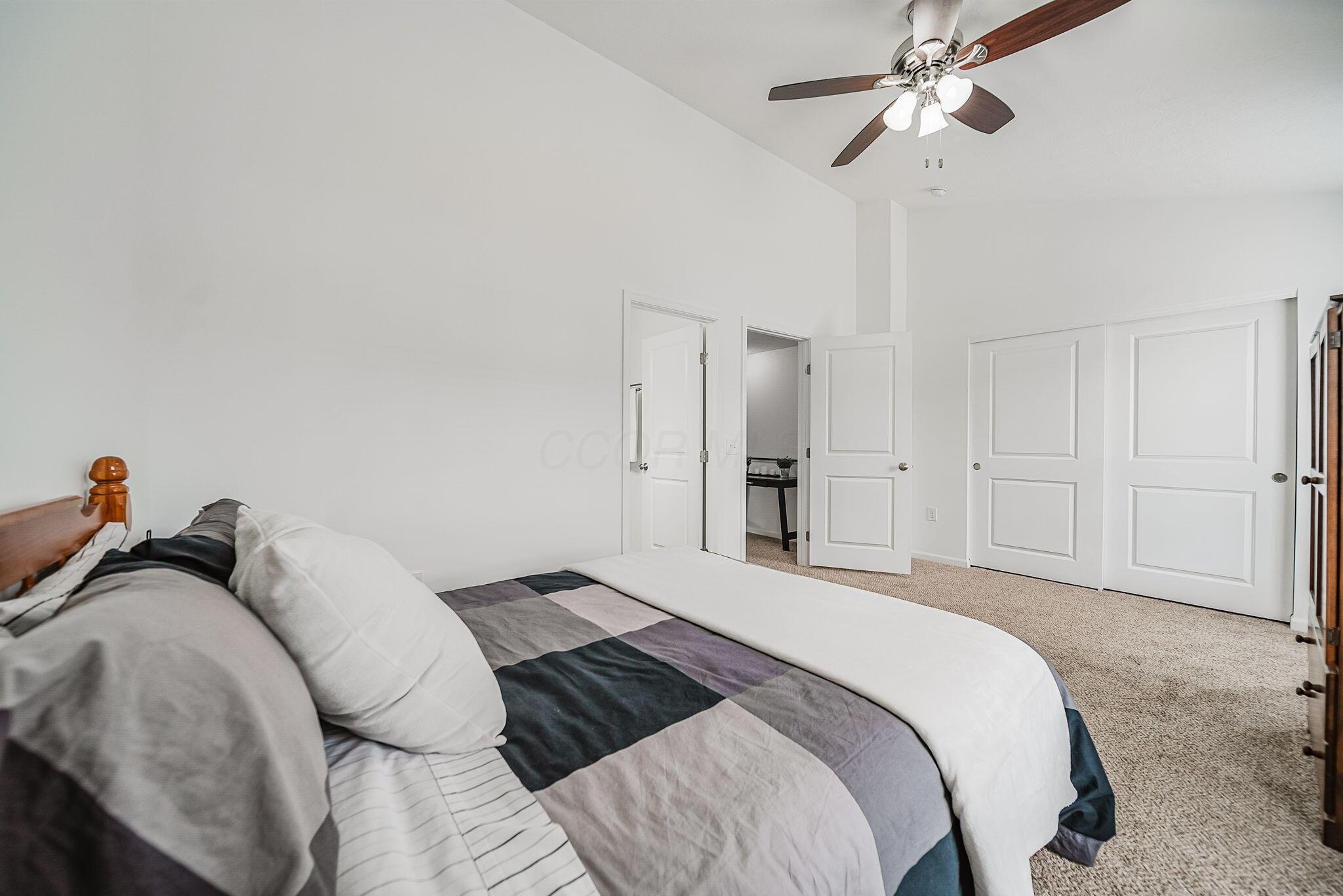 6186 Needletail Road, Unit 66 Columbus, OH 43230 - Photo 21 of 48 Bedroom #2 also has vaulted ceilings, neutral decor, overhead lighting/fan, it's own private en-suite bathroom and a WHOLE WALL of closet space!