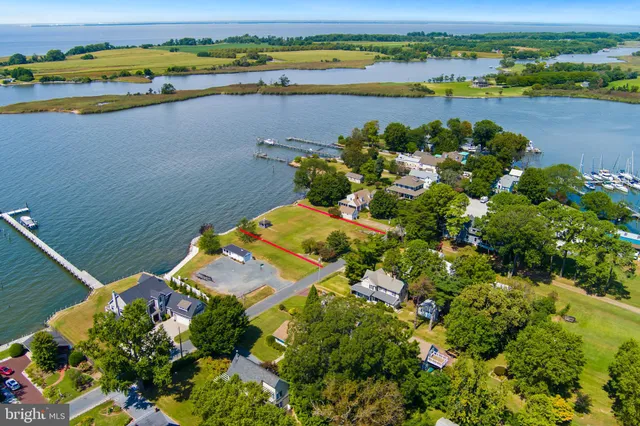an aerial view of a residential houses with outdoor space and city view