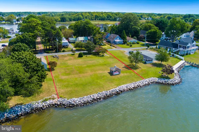a view of a swimming pool with lawn chairs under an umbrella