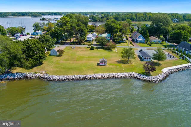an aerial view of a house with a swimming pool outdoor seating and yard