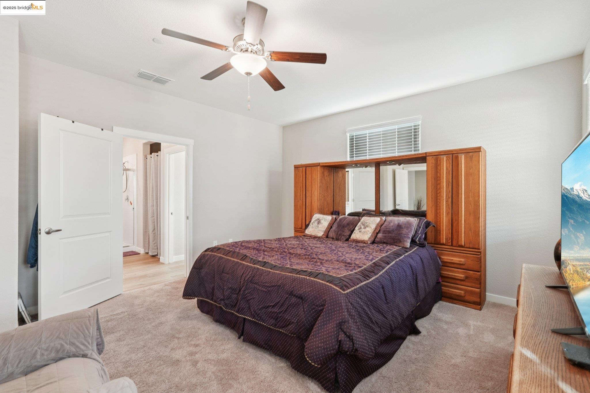 2119 Revival Lane Rio Vista, CA 94571 - Photo 17 of 44 a bedroom with a bed ceiling fan and a wooden floor