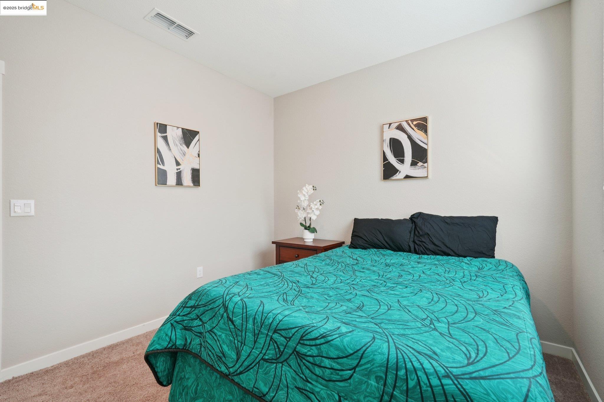 2119 Revival Lane Rio Vista, CA 94571 - Photo 24 of 44 a bedroom with a bed and painting on the wall