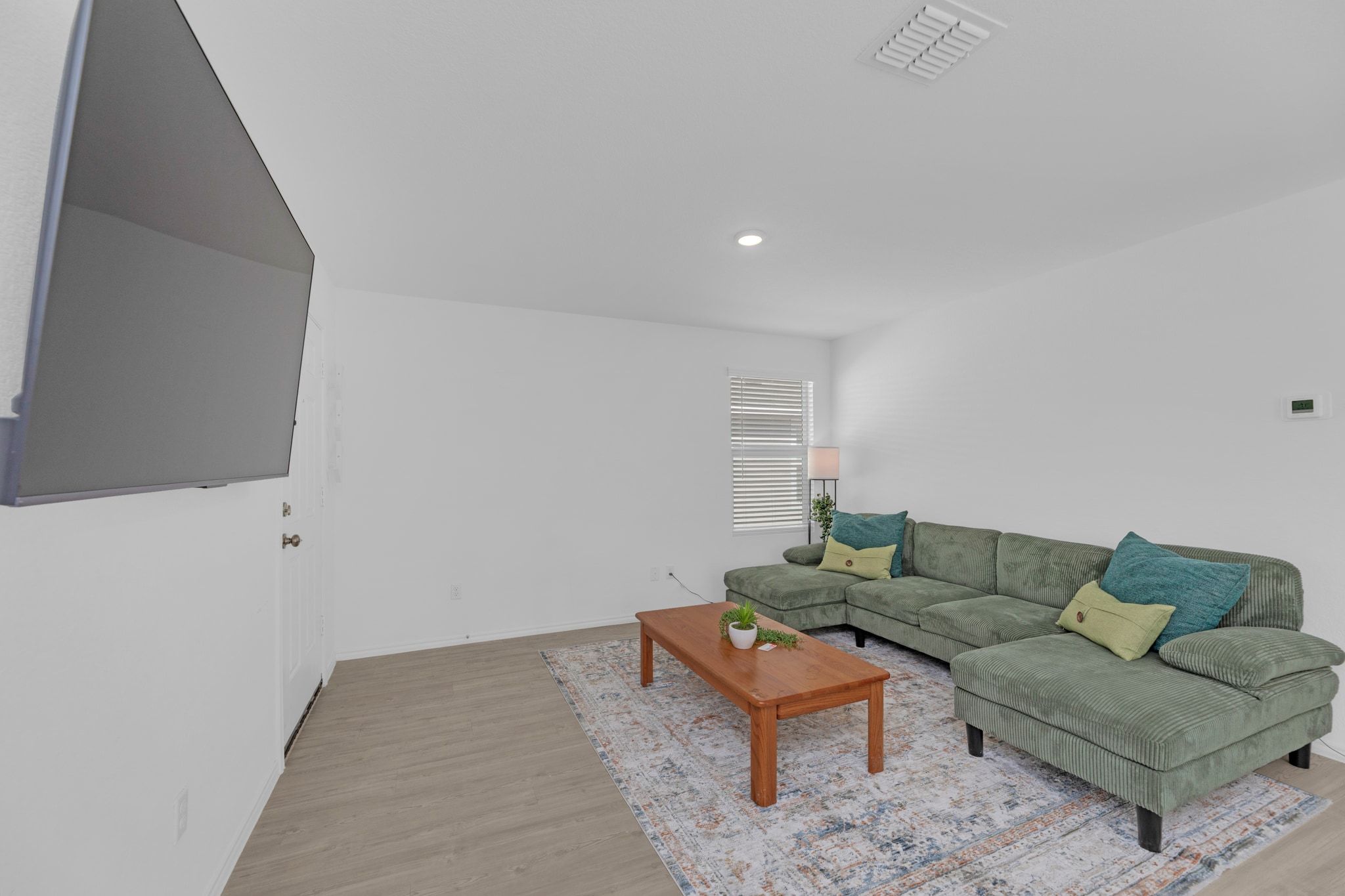 353 Marty Allen Loop Jarrell, TX 76537 - Photo 11 of 34 a living room with furniture a rug and a wooden floor