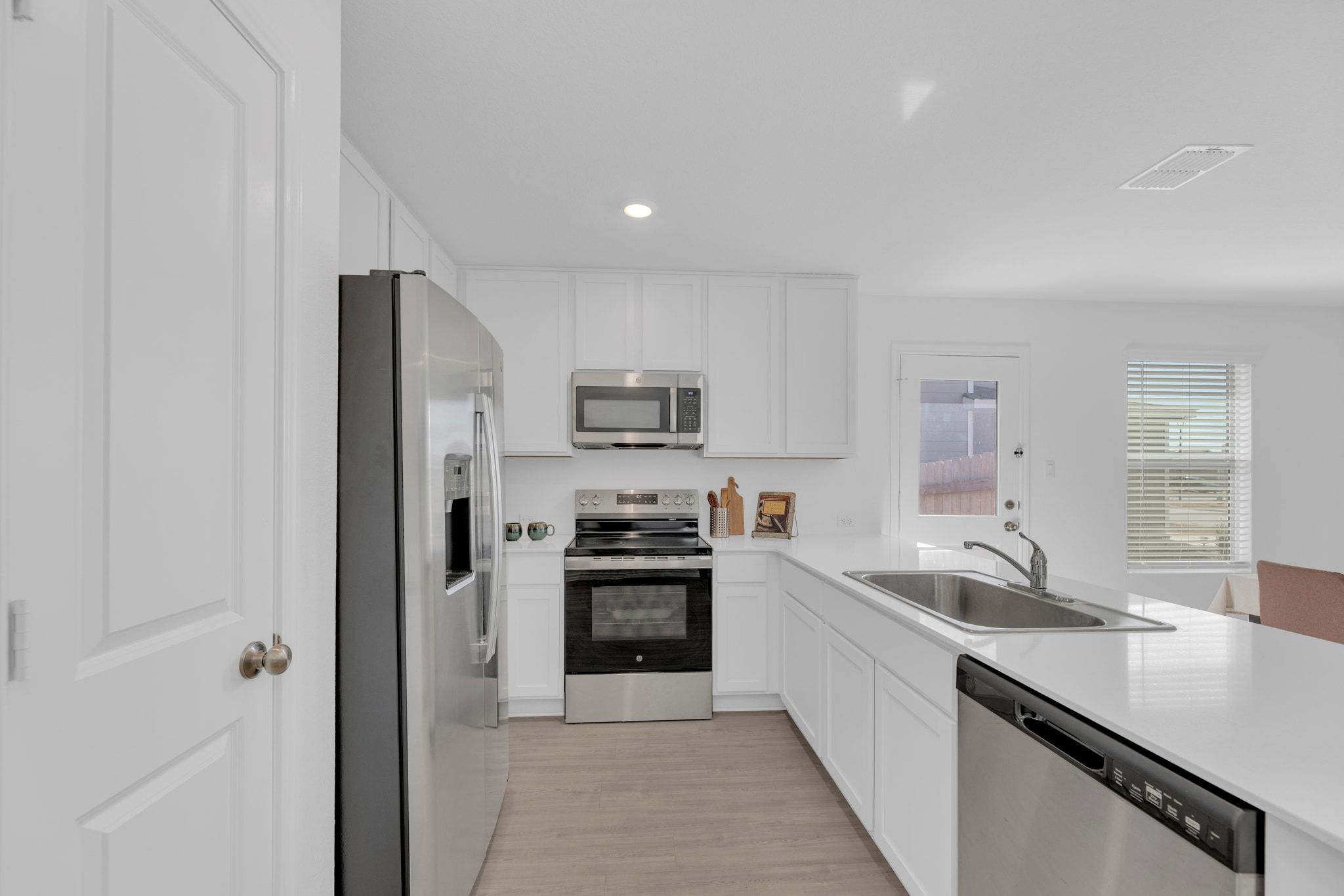 353 Marty Allen Loop Jarrell, TX 76537 - Photo 13 of 34 a large kitchen with stainless steel appliances granite countertop a refrigerator and a sink