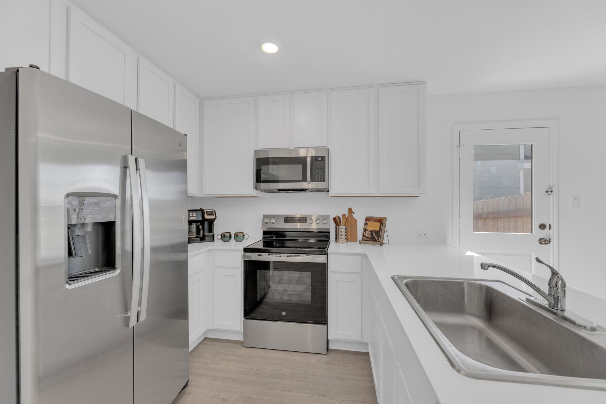 353 Marty Allen Loop Jarrell, TX 76537 - Photo 15 of 34 a kitchen with a sink stove and refrigerator