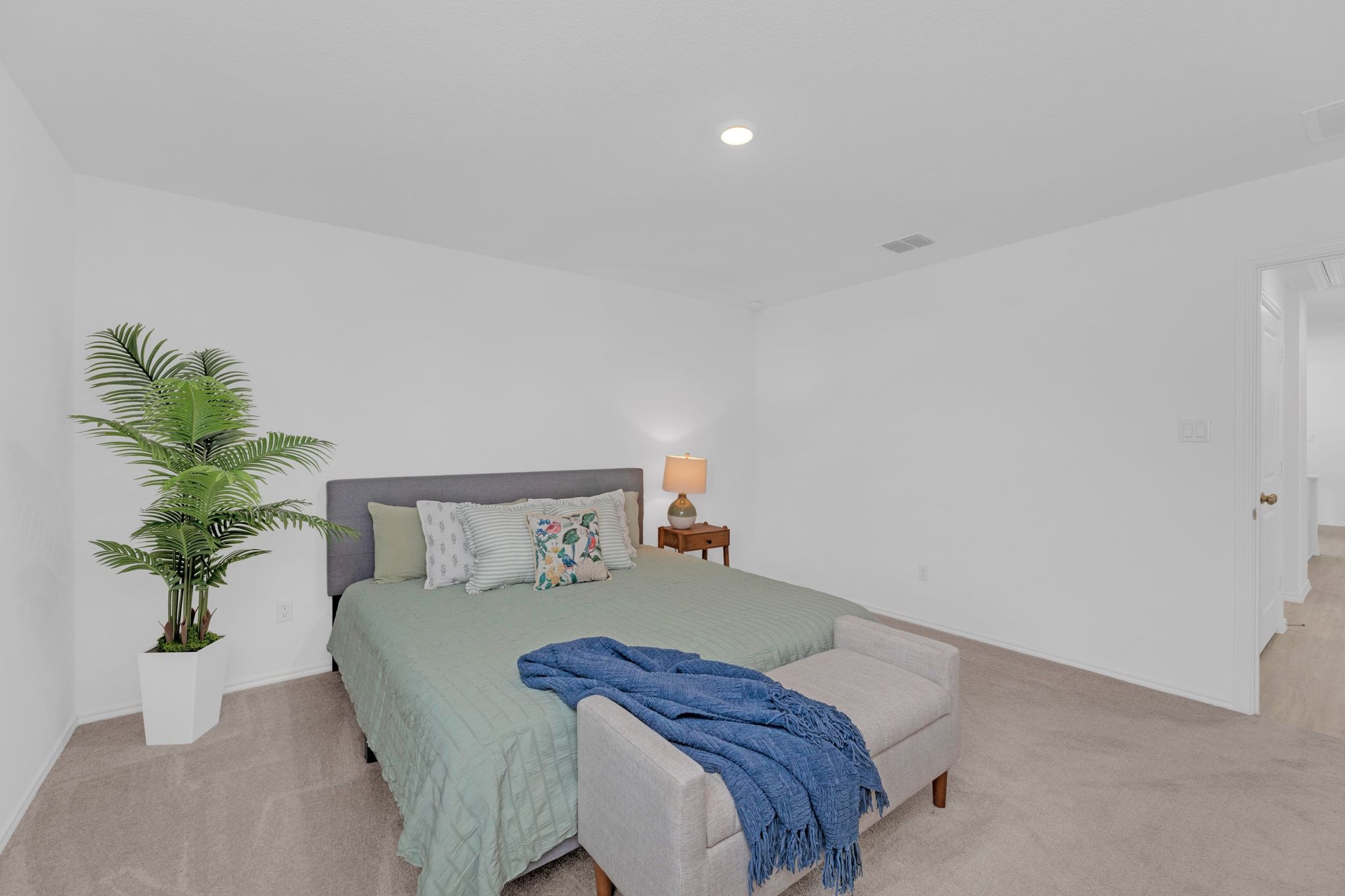 353 Marty Allen Loop Jarrell, TX 76537 - Photo 16 of 34 a bedroom with a bed and a potted plant