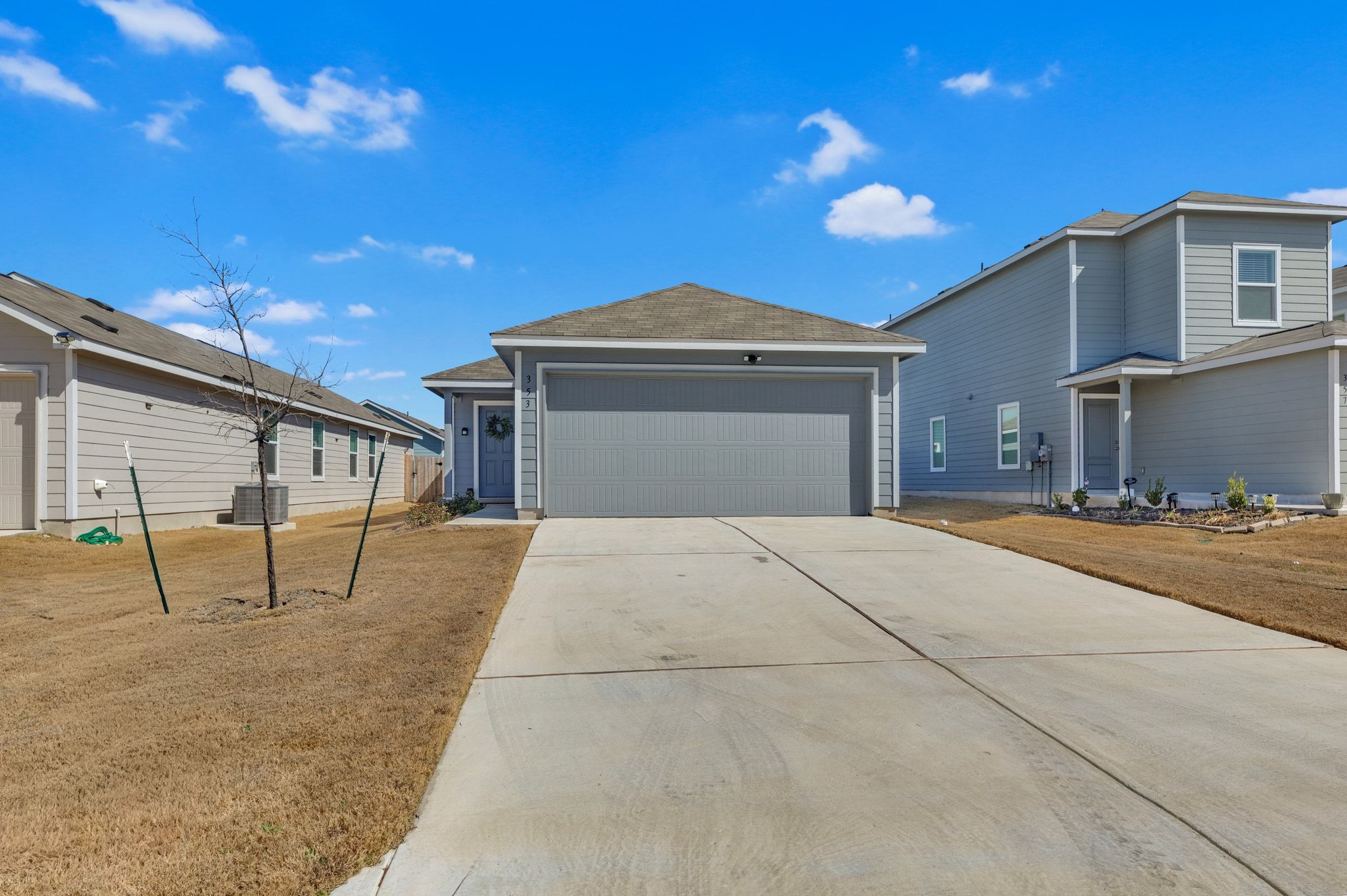 353 Marty Allen Loop Jarrell, TX 76537 - Photo 2 of 34 a front view of a house with a yard and garage