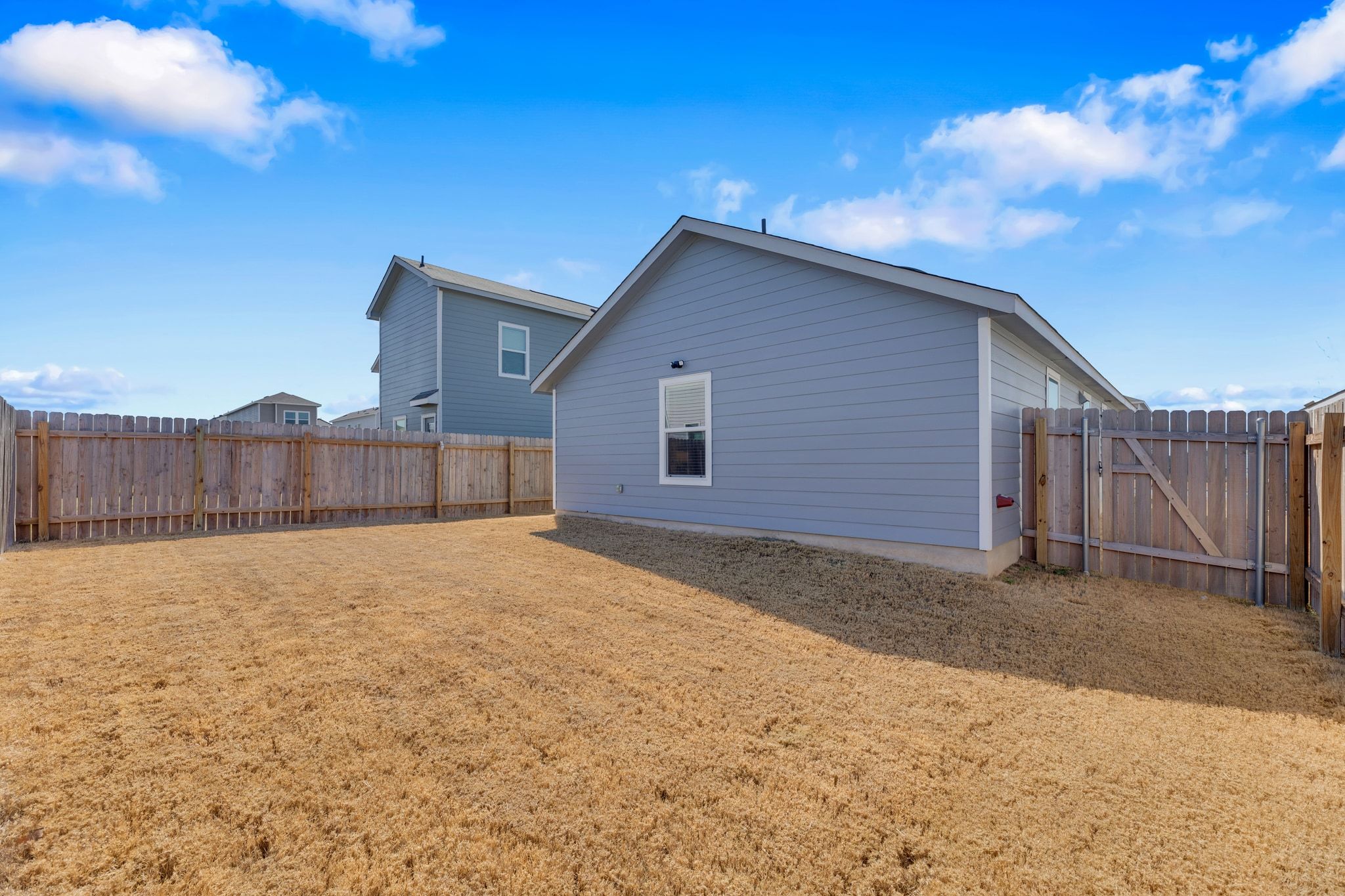 353 Marty Allen Loop Jarrell, TX 76537 - Photo 24 of 34 a view of an house with backyard and wooden fence