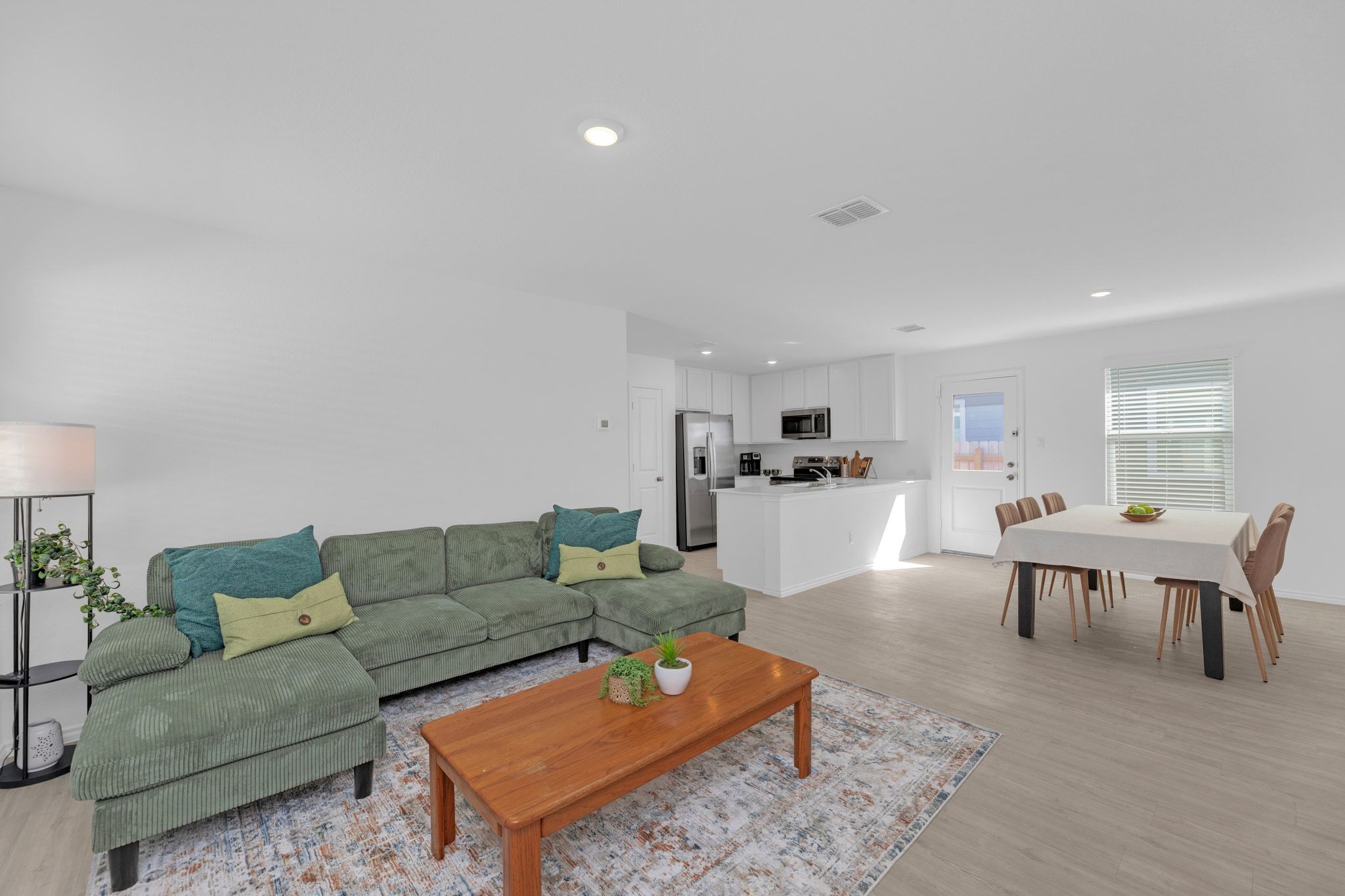 353 Marty Allen Loop Jarrell, TX 76537 - Photo 3 of 34 a living room with furniture a rug kitchen view and a table