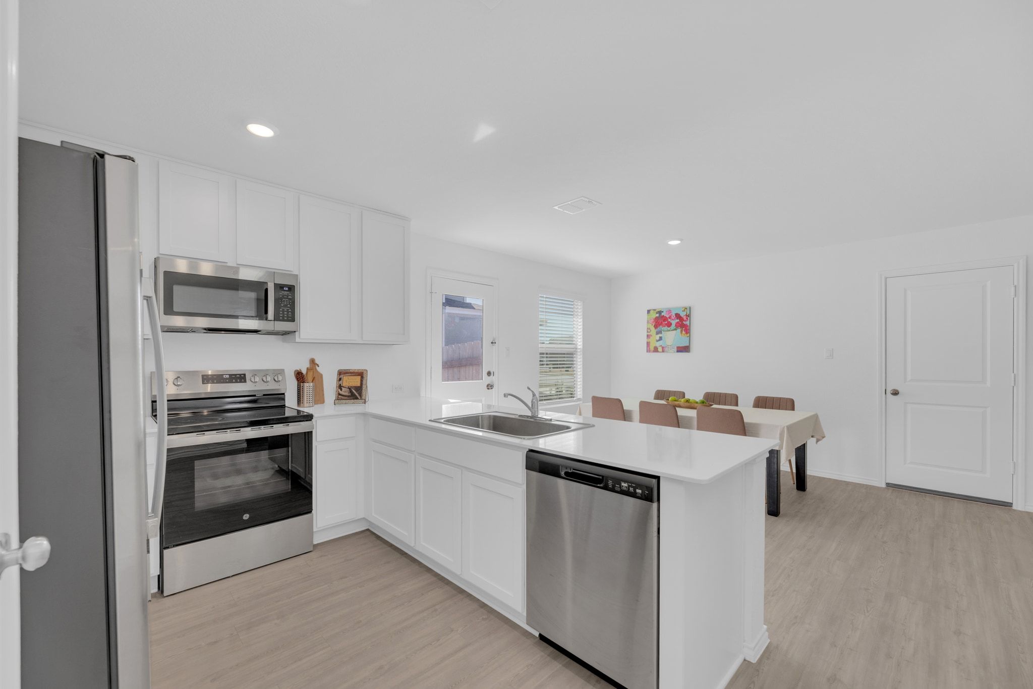 353 Marty Allen Loop Jarrell, TX 76537 - Photo 4 of 34 a kitchen with a sink stove and refrigerator