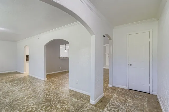 an empty room with closet and windows