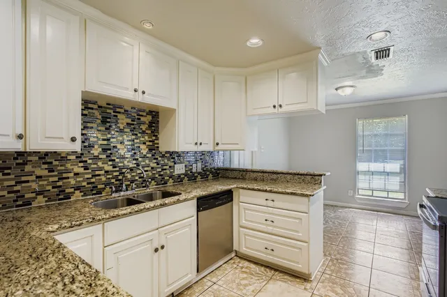 a kitchen with granite countertop cabinets and steel stainless steel appliances