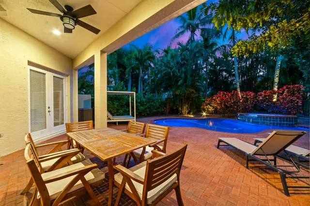a view of swimming pool with seating area and garden
