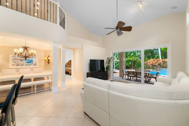 a view of a livingroom with furniture hardwood floor and windows