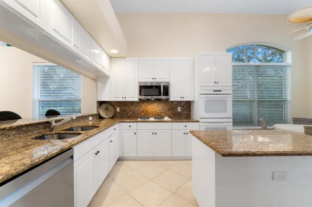 a kitchen with granite countertop a sink and a stove