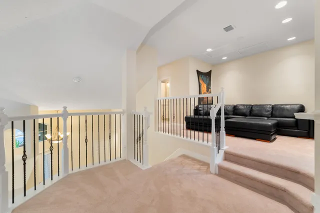 a living room with lots of furniture and a floor to ceiling window