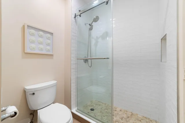 a bathroom with a toilet and a shower