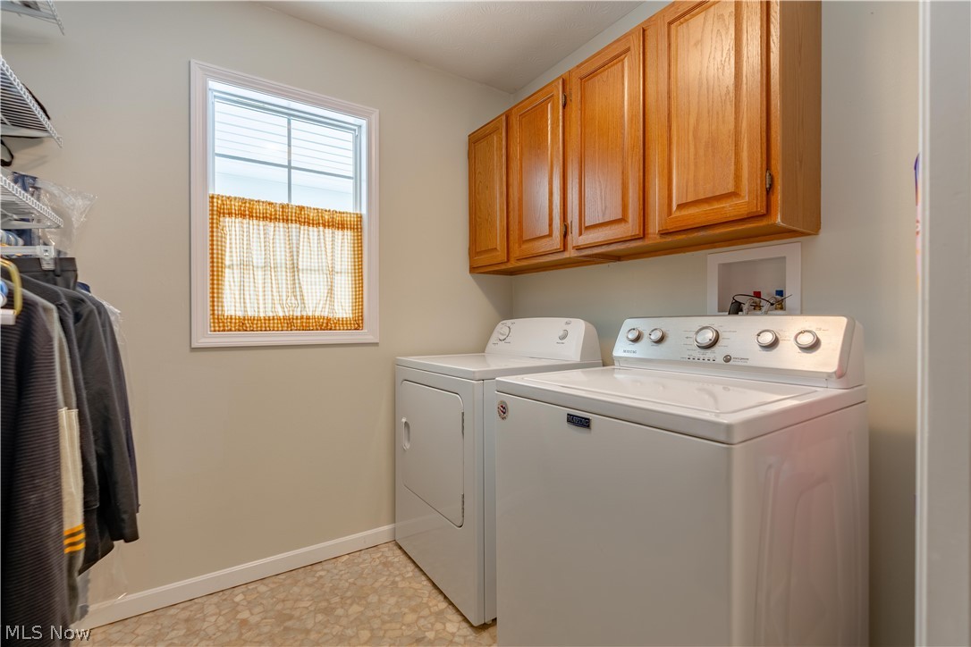4057 Bramshaw Road Northwest Canton, OH 44718 - Photo 22 of 47 First floor laundry with cabinets and shelving.
