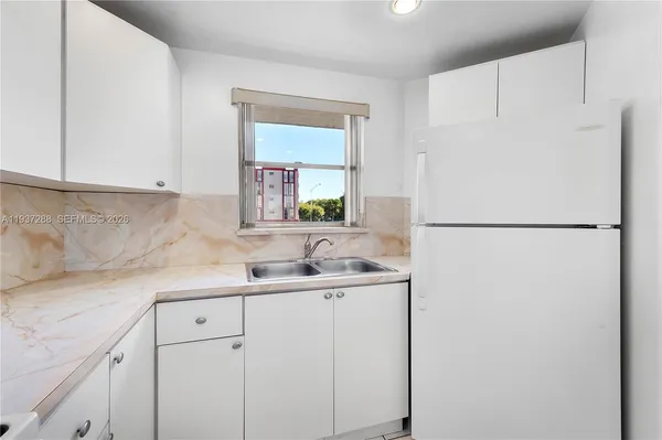 a view of a kitchen with natural light