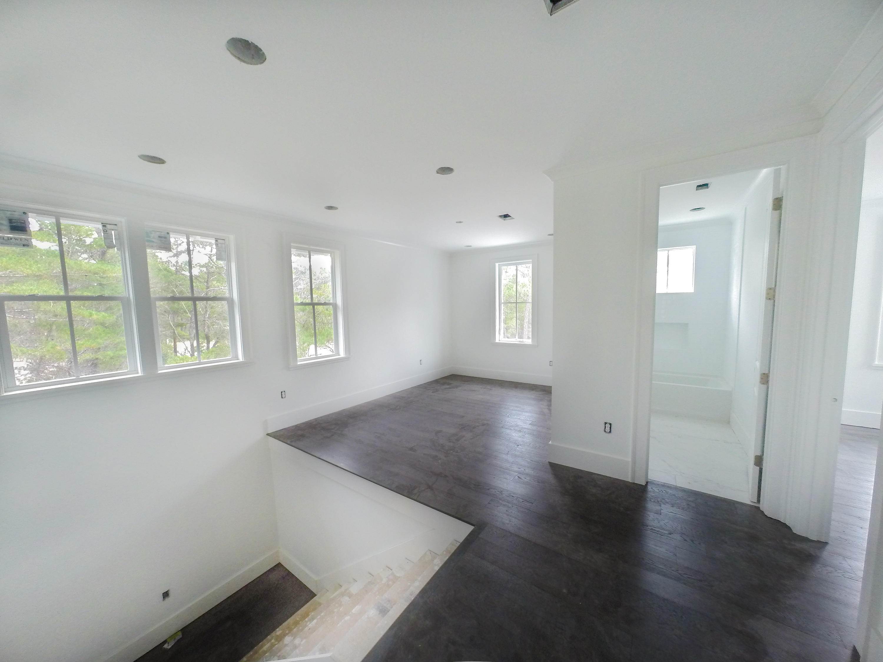 384 Matt's Way Santa Rosa Beach, FL 32459 - Photo 22 of 32 an empty room with wooden floor and windows