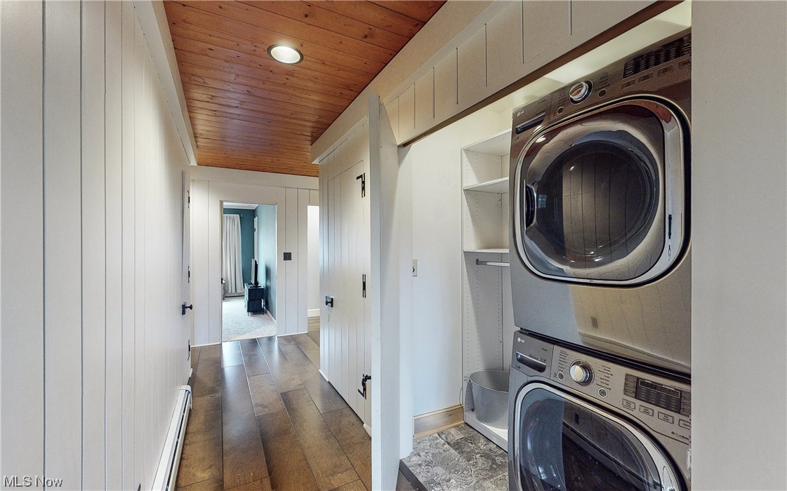 320 Ely Road Akron, OH 44313 - Photo 24 of 36 Laundry area featuring stacked washing maching and dryer, dark hardwood / wood-style flooring, a baseboard radiator, and wooden ceiling