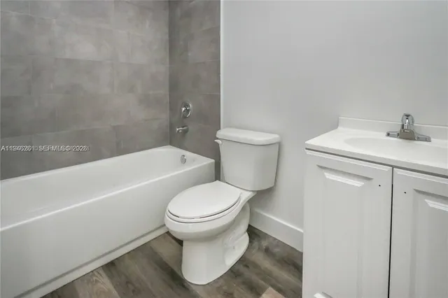 a white toilet sitting next to a bath tub