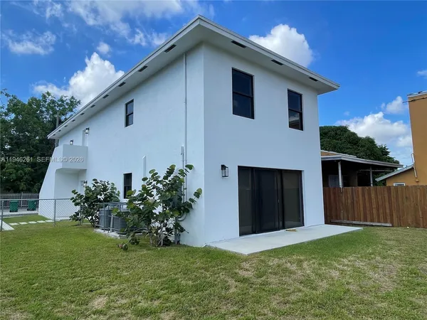 a house that has a big yard with wooden fence