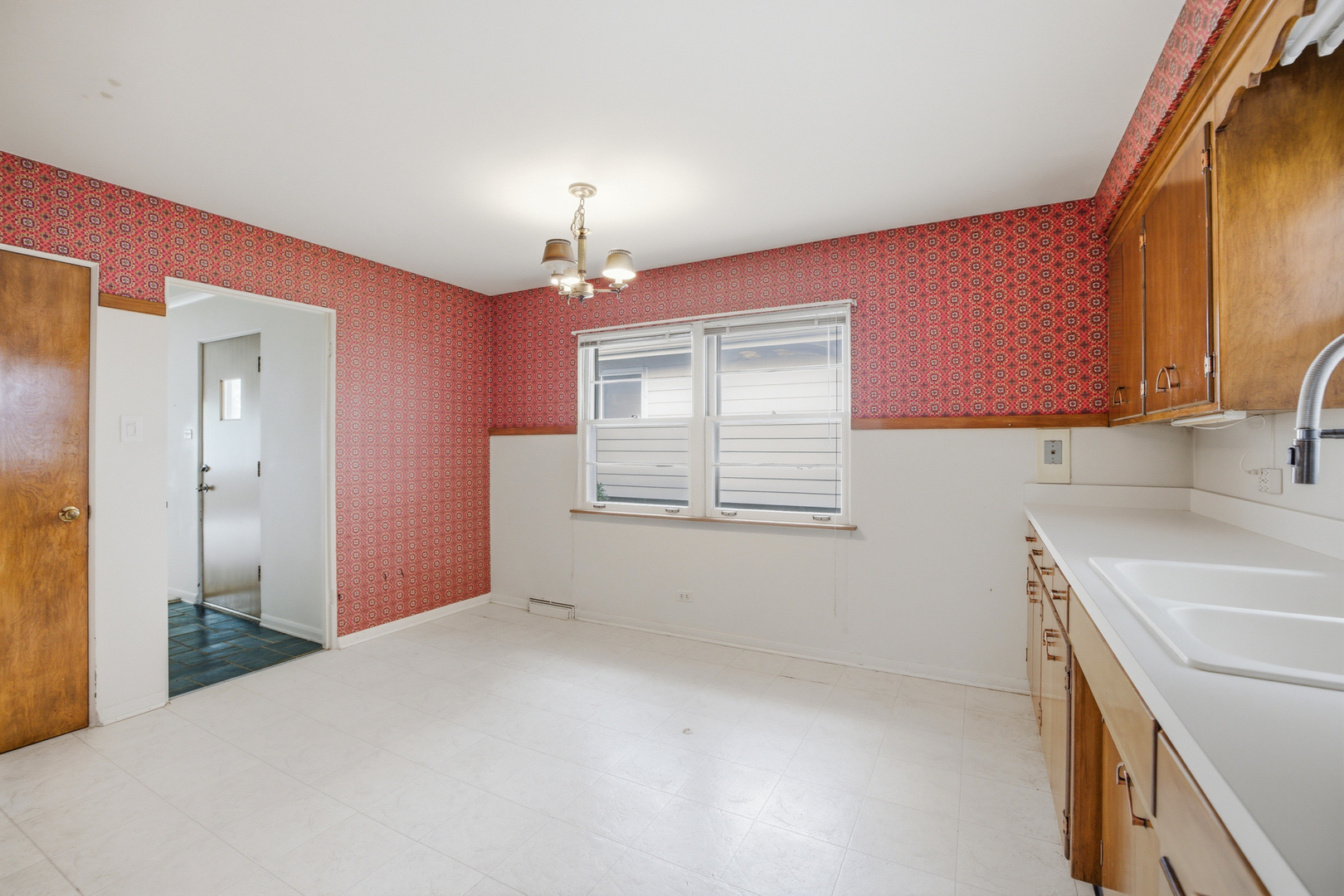 1020 Pershing Avenue Wheaton, IL 60189 - Photo 11 of 33 a view of a kitchen with a sink cabinets and a window