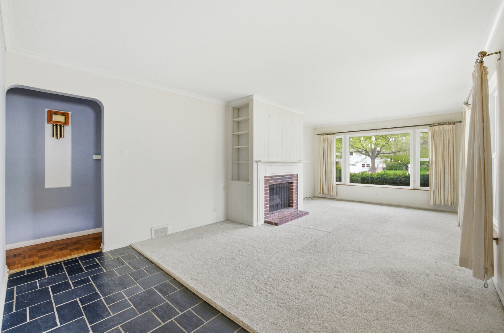 1020 Pershing Avenue Wheaton, IL 60189 - Photo 4 of 33 an empty room with floor to ceiling window and fireplace