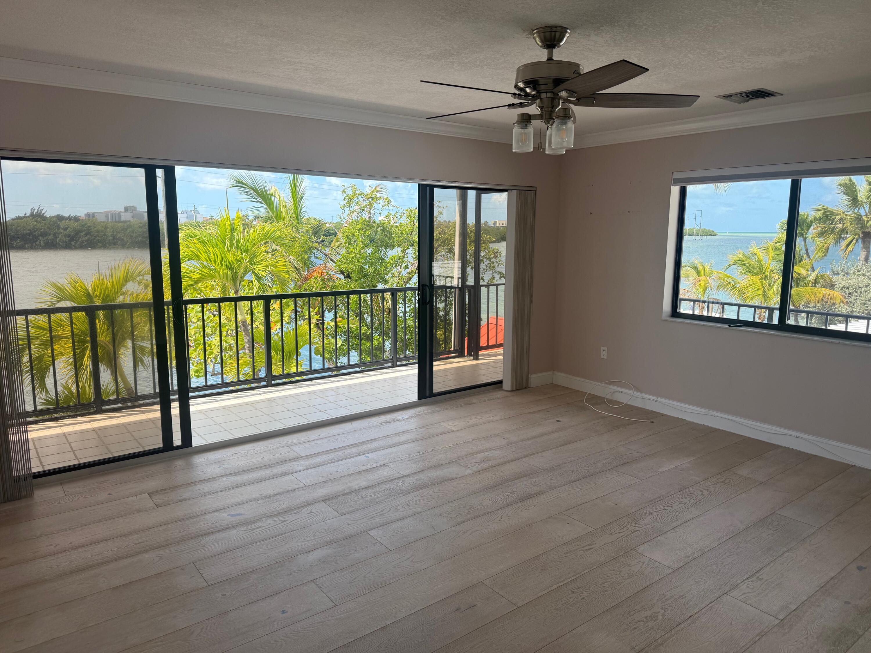 117 Key Haven Road Key West, FL 33040 - Photo 4 of 5 wooden floor in an empty room with a window
