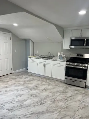 a kitchen with stainless steel appliances granite countertop a stove and a sink
