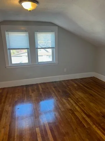a view of a room with wooden floors and window
