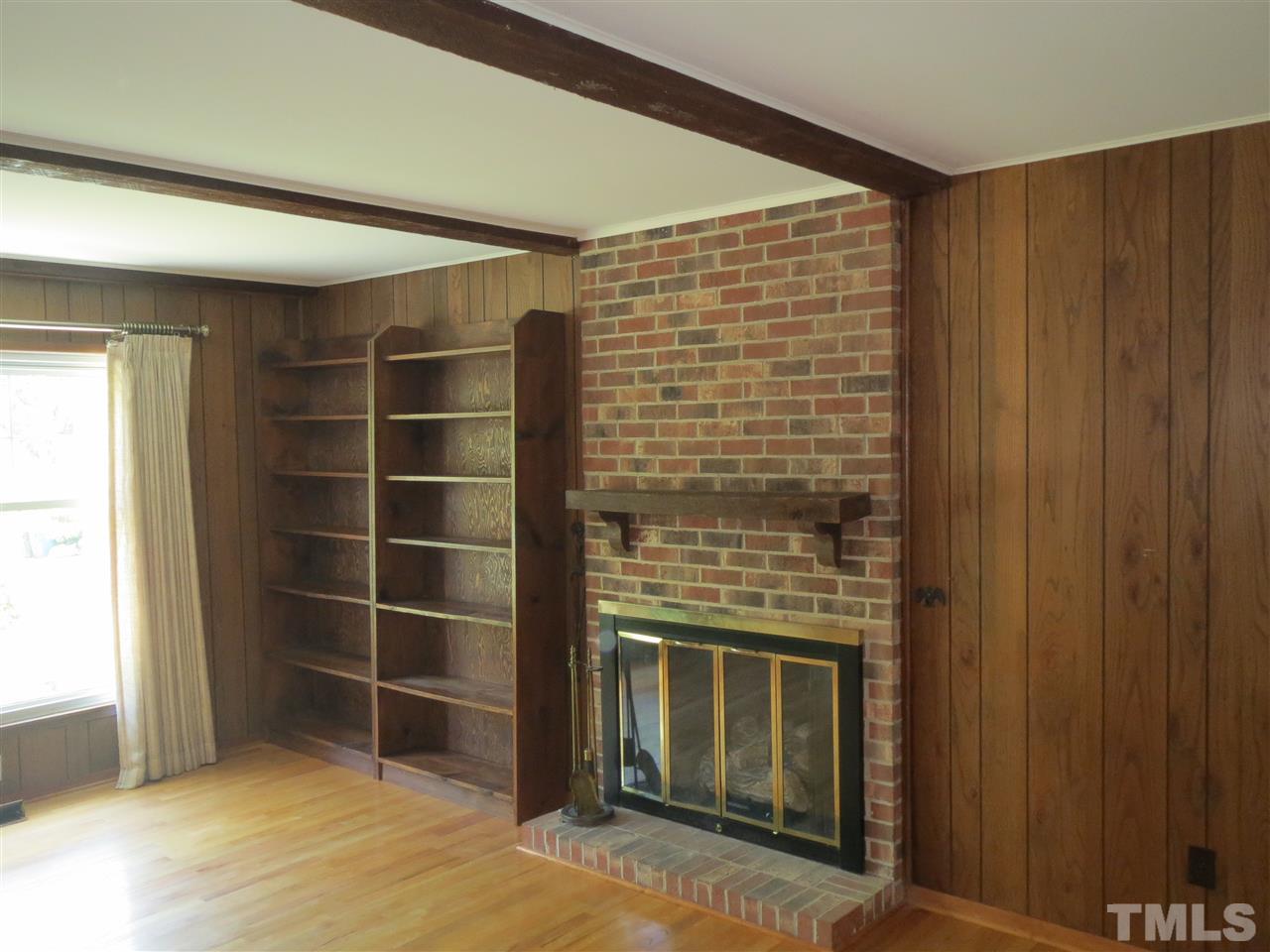 5306 Pelham Road Durham, NC 27713 - Photo 5 of 25 a view of an empty room with wooden floor and a window