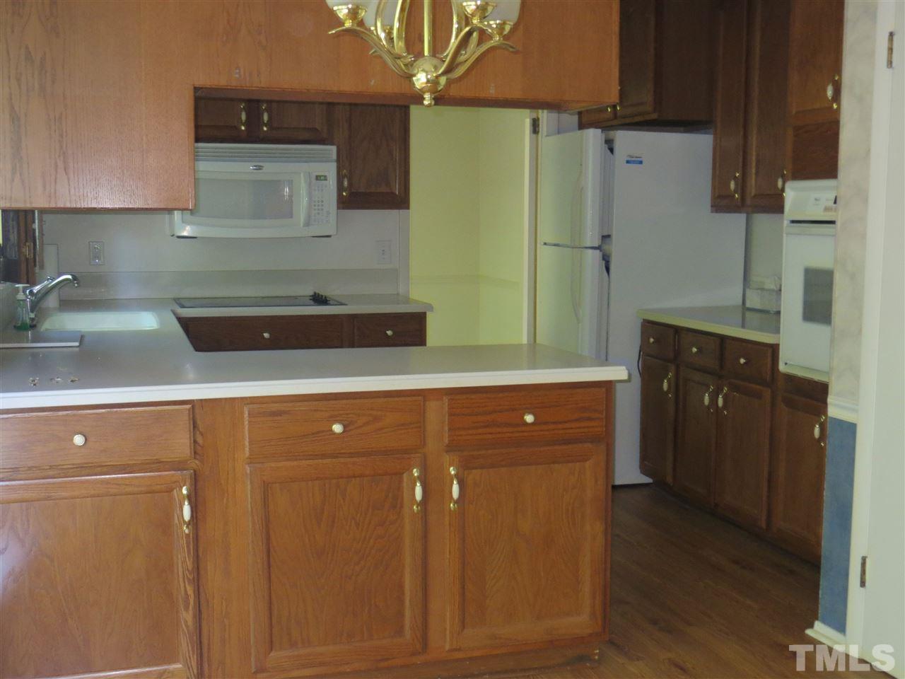 5306 Pelham Road Durham, NC 27713 - Photo 7 of 25 a kitchen with stainless steel appliances a refrigerator and cabinets