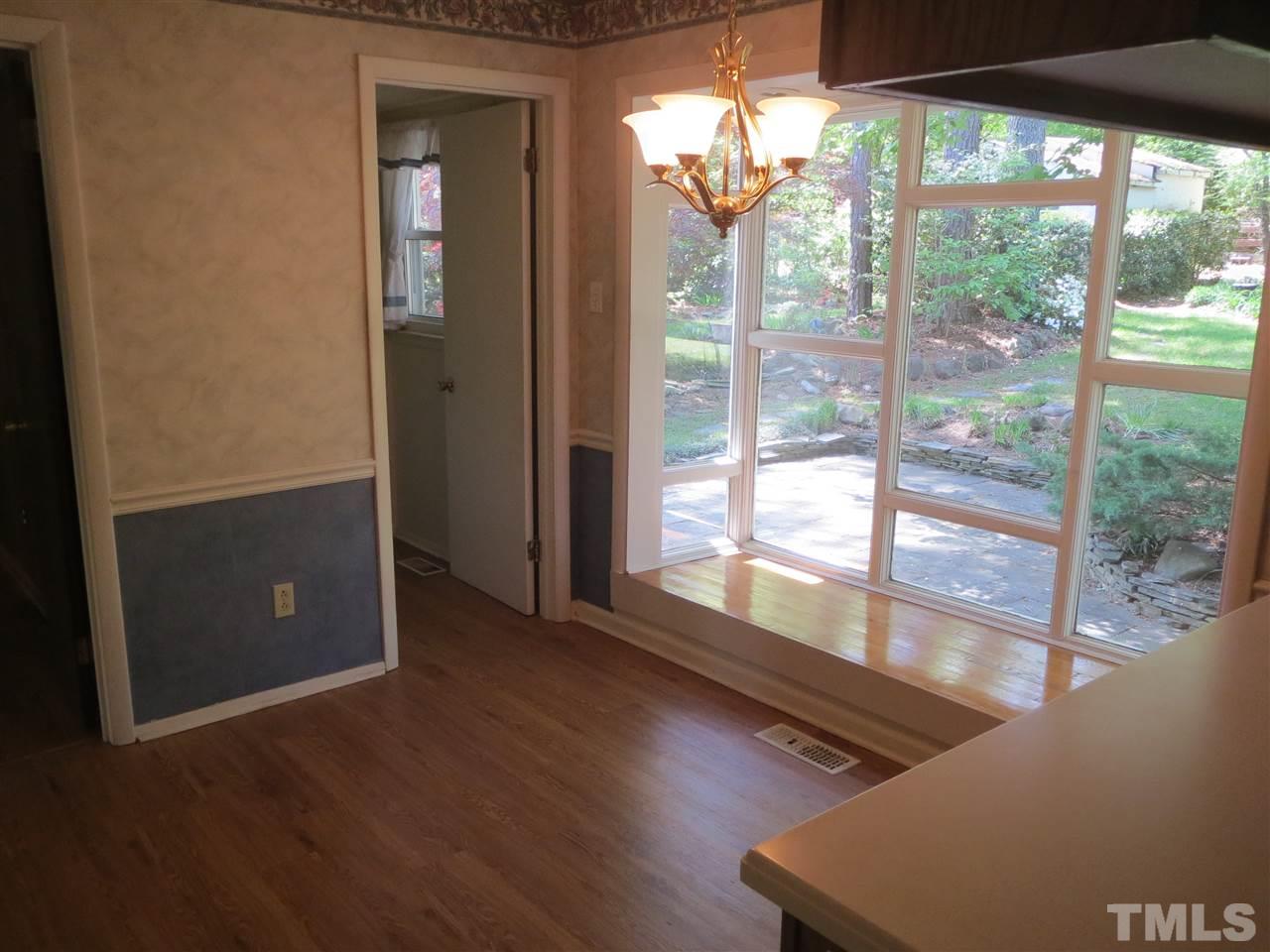 5306 Pelham Road Durham, NC 27713 - Photo 9 of 25 a view of a room with wooden floor and windows