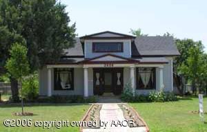 a view of a brick house with a yard
