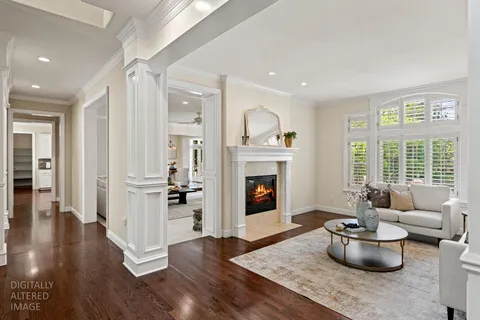 a kitchen with stainless steel appliances granite countertop a stove top oven a sink dishwasher a dining table and chairs with wooden floor