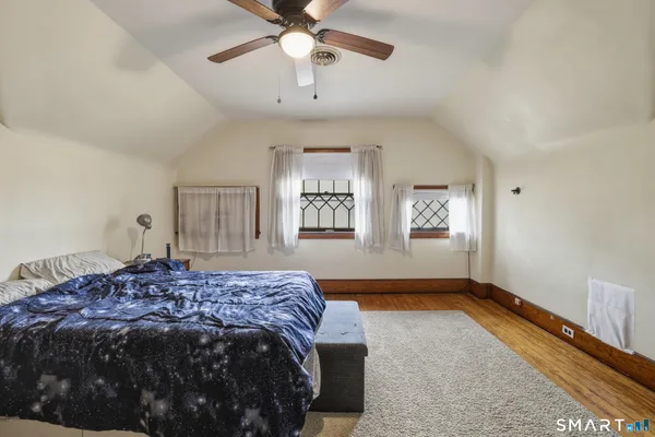 a spacious bedroom with a bed and a dresser