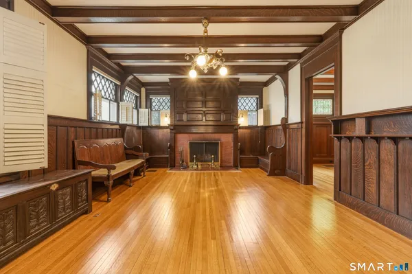 wooden floor in an empty room with a fireplace