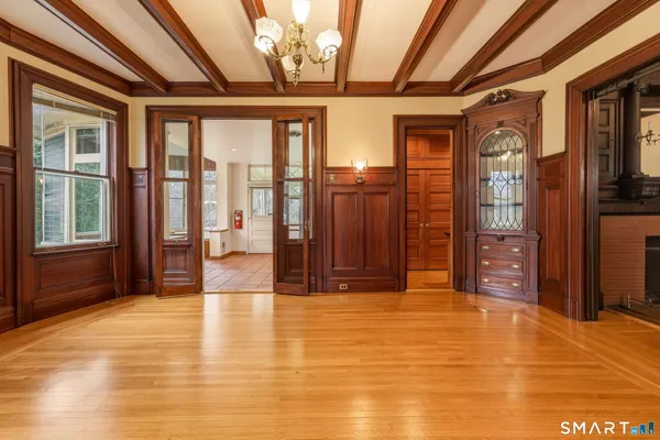 a big room with wooden floor and windows