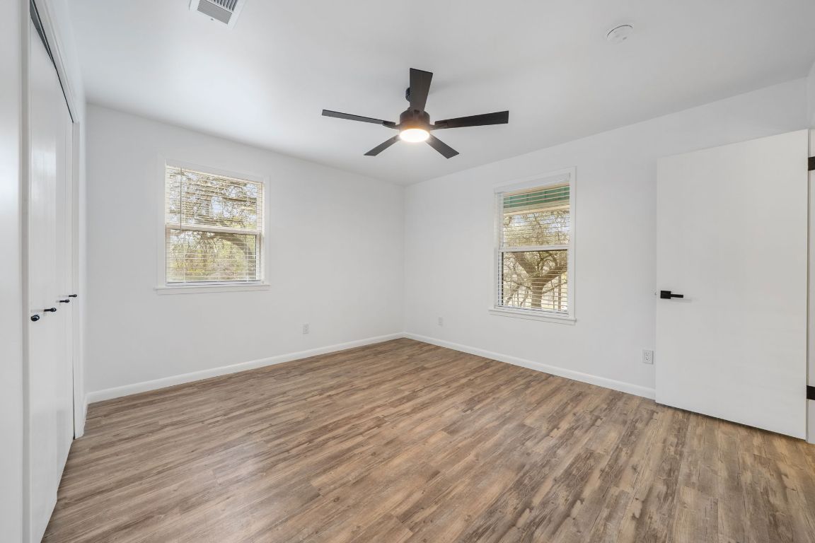 2175 Park Road New Braunfels, TX 78132 - Photo 23 of 39 Empty room featuring light wood-style flooring, healthy amount of natural light, and a ceiling fan